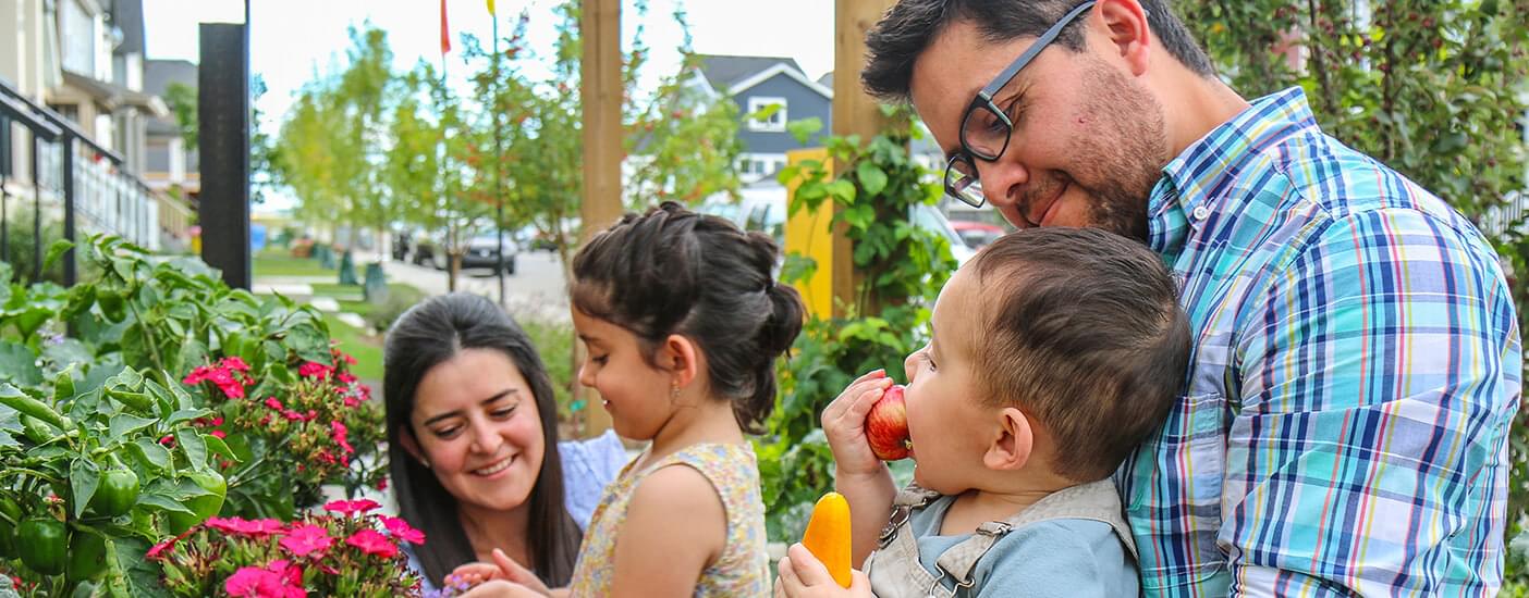 Family harvesting plants with children